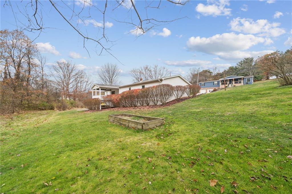 1619 Kennedy Road Imperial, PA 15126 - Photo 23 of 40 a view of a big yard with table and chairs under an umbrella