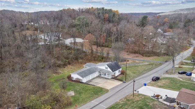 a view of a yard with a house and a tree