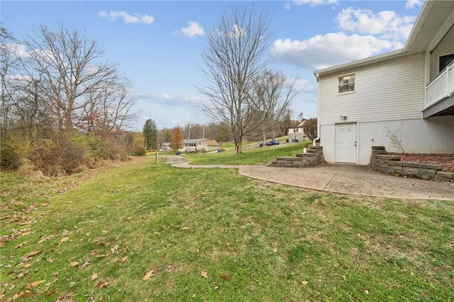 a view of a house with a backyard and a garden