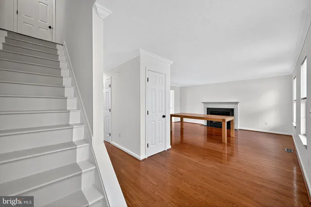 a view of entryway with stairs and wooden floor