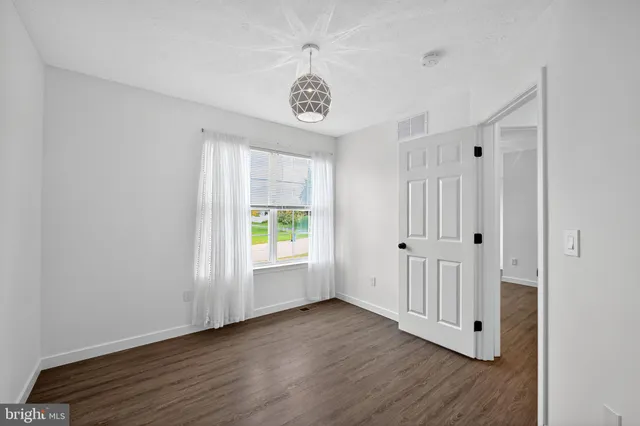 a view of an entryway with wooden floor