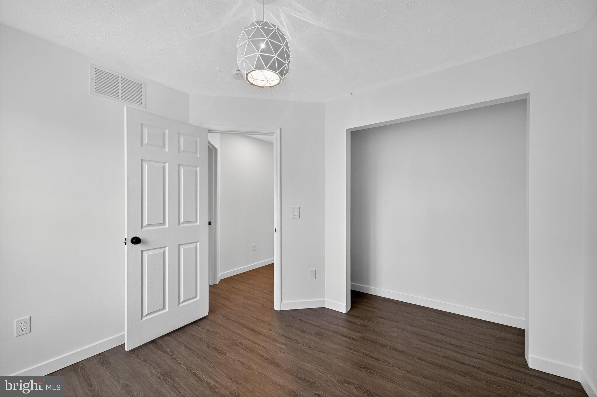 231 Cool Spring Lane Stewartstown, PA 17363 - Photo 14 of 27 an empty room with wooden floor and a window