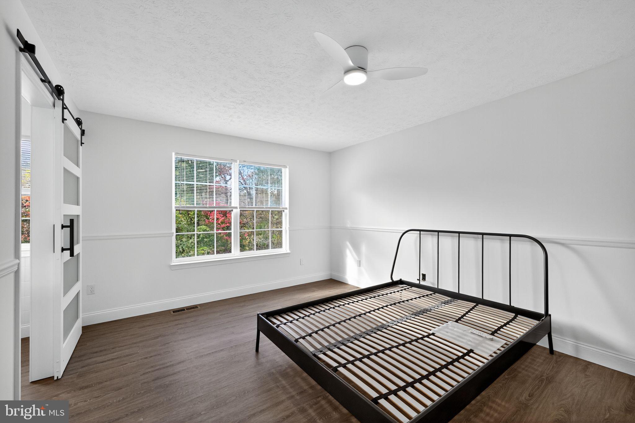 231 Cool Spring Lane Stewartstown, PA 17363 - Photo 17 of 27 a view of an empty room with wooden floor and a window
