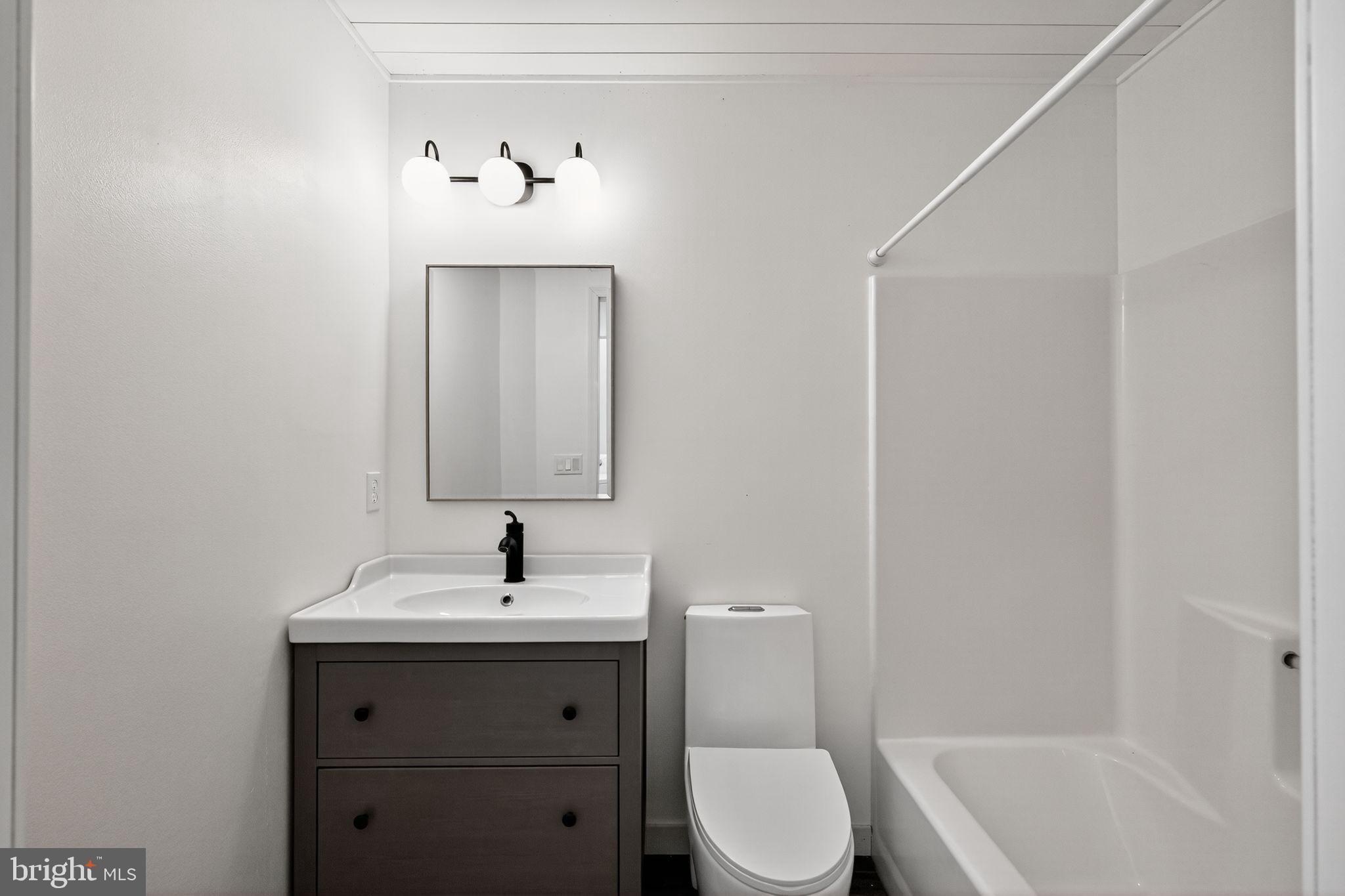 231 Cool Spring Lane Stewartstown, PA 17363 - Photo 19 of 27 a bathroom with a sink a toilet and shower