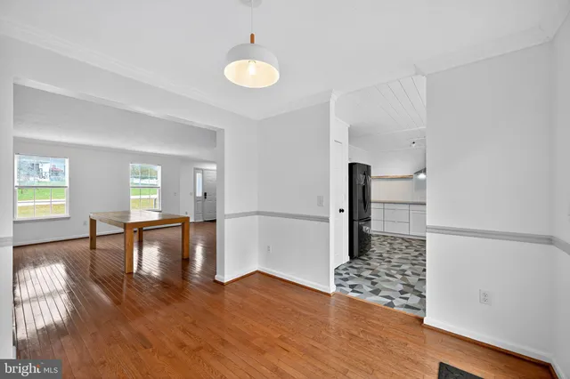 a view of empty room with wooden floor and chair