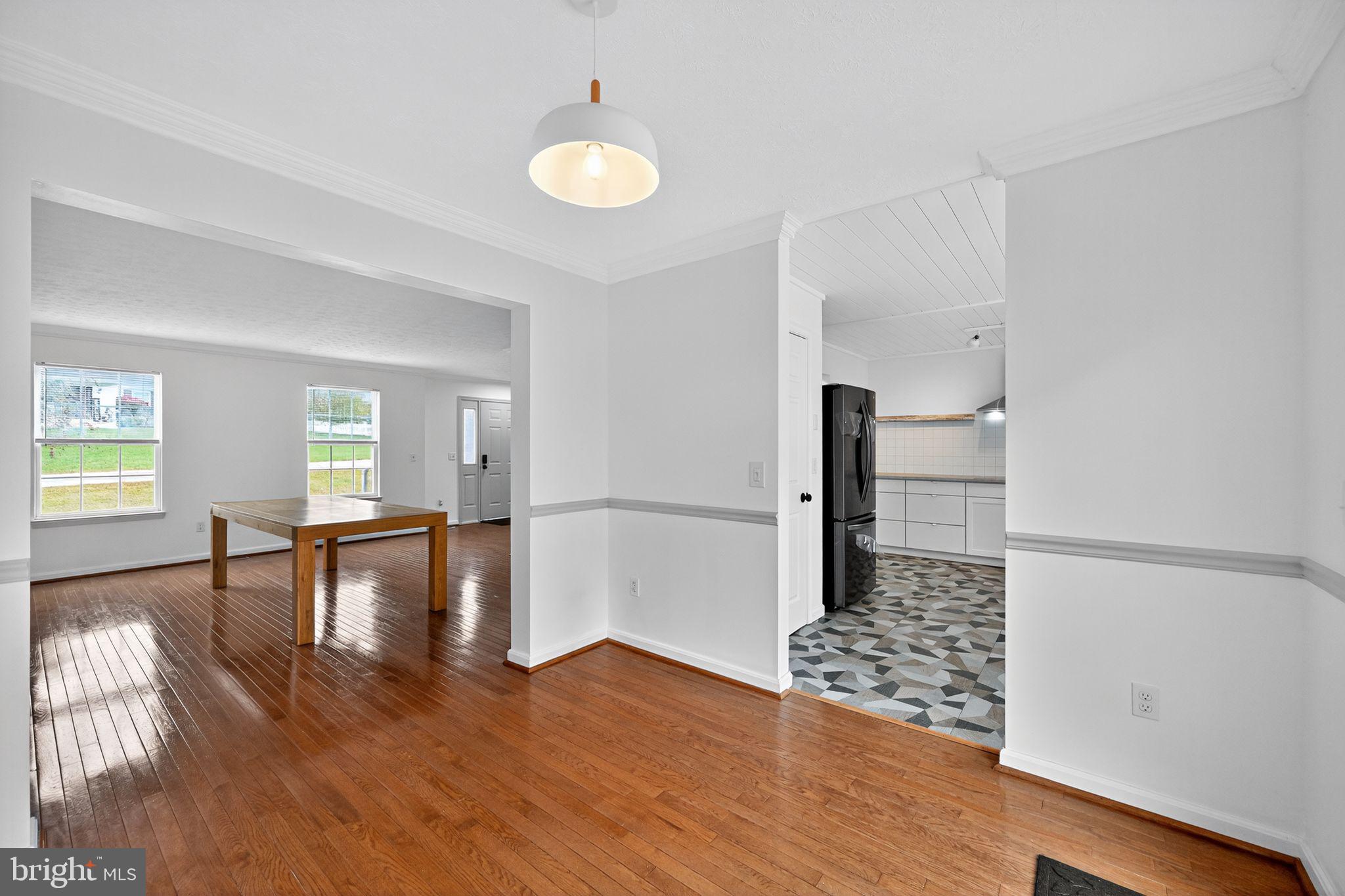 231 Cool Spring Lane Stewartstown, PA 17363 - Photo 5 of 27 a view of empty room with wooden floor and chair