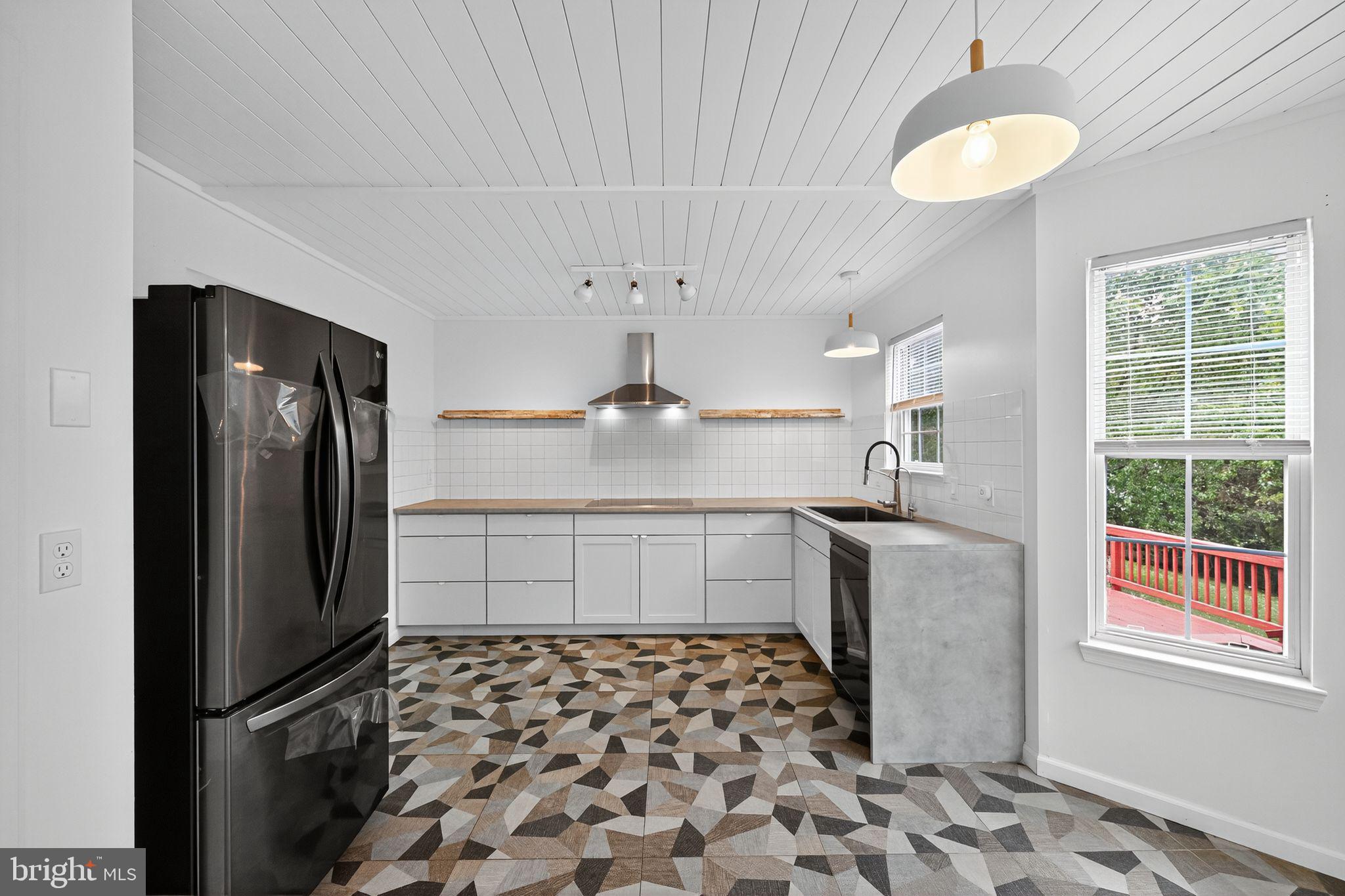 231 Cool Spring Lane Stewartstown, PA 17363 - Photo 6 of 27 a kitchen with stainless steel appliances granite countertop a refrigerator and a sink