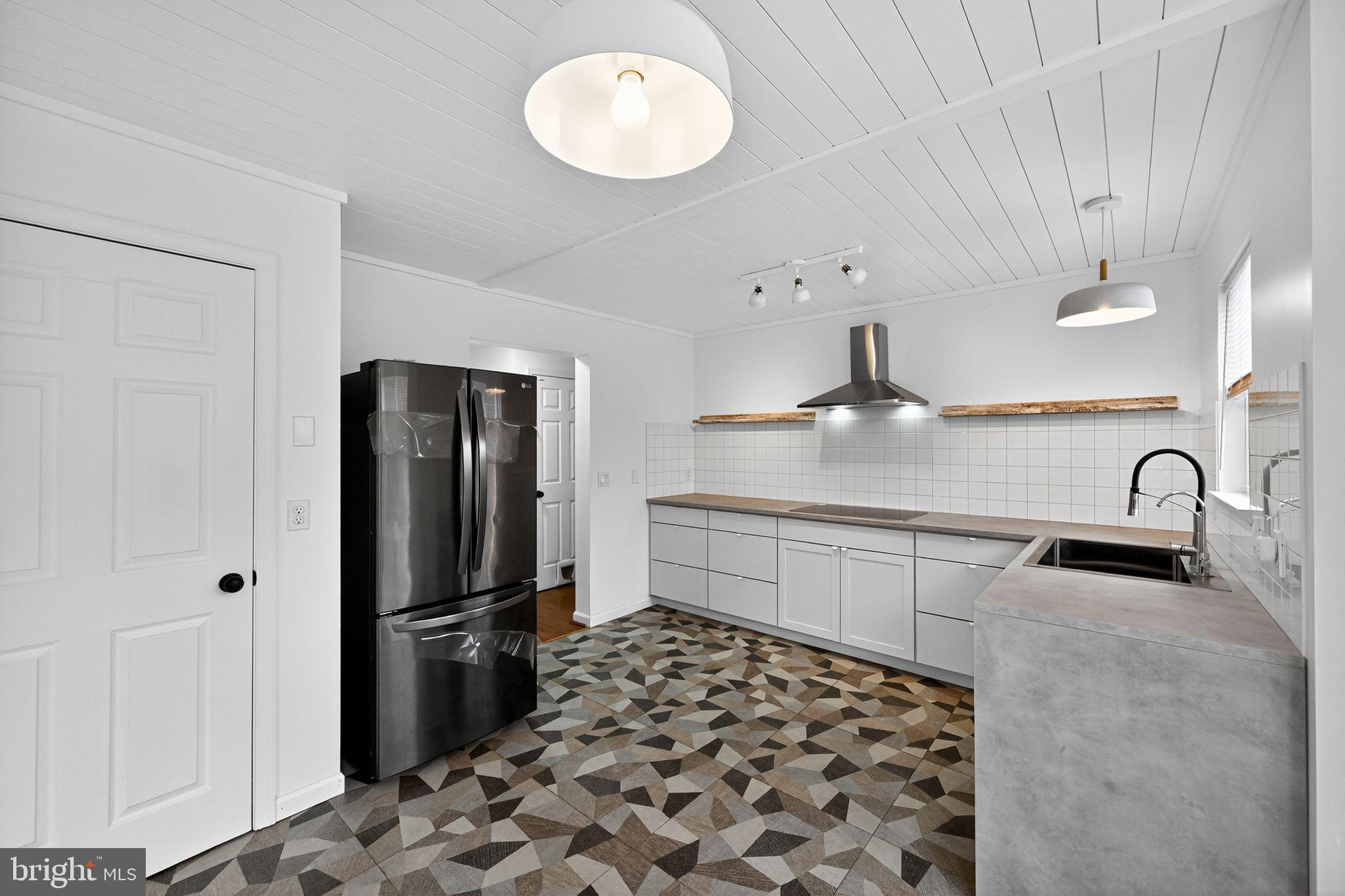 231 Cool Spring Lane Stewartstown, PA 17363 - Photo 7 of 27 a kitchen with stainless steel appliances granite countertop a refrigerator and a sink