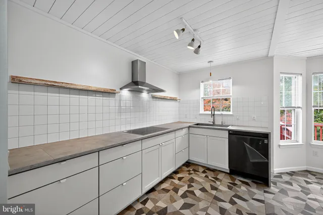 a kitchen with stainless steel appliances granite countertop a sink and cabinets