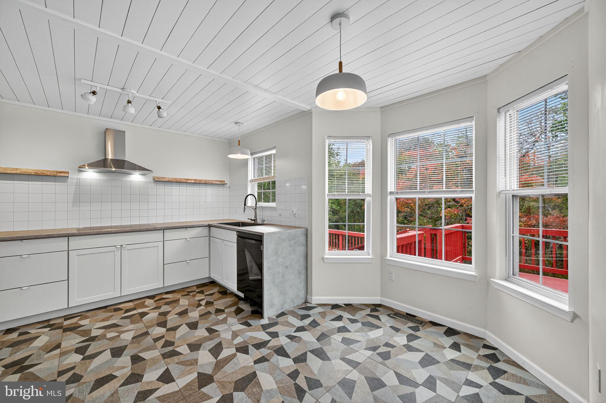 231 Cool Spring Lane Stewartstown, PA 17363 - Photo 9 of 27 a kitchen with a stove a sink and a window
