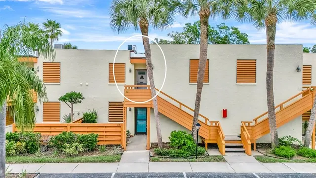 a front view of a house with a yard and potted plants