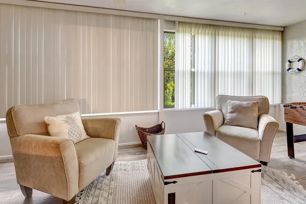 a living room with furniture and a large window