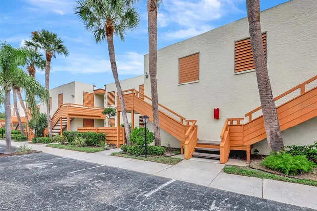 a kitchen with cabinets and chairs