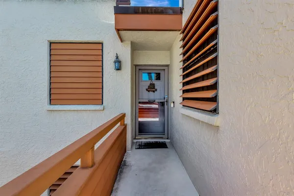 a hallway with a white cabinet and a hallway