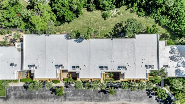an aerial view of multiple house with yard and outdoor seating