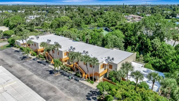 an aerial view of a house with a yard