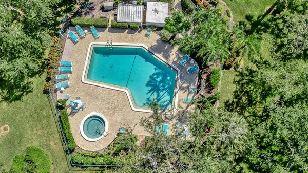 an aerial view of a house with outdoor space and garden