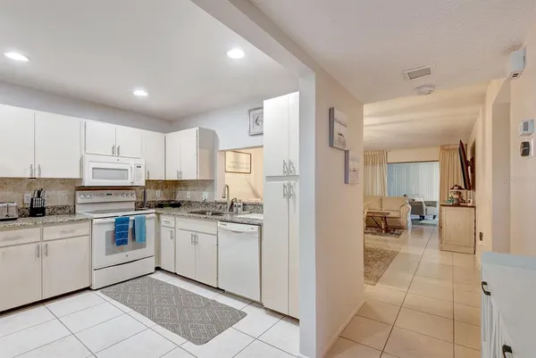 a kitchen with cabinets and chairs