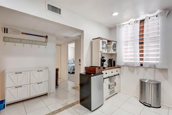 a kitchen with granite countertop a stove a sink and a refrigerator