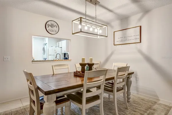 a view of a dining area with furniture and a chandelier