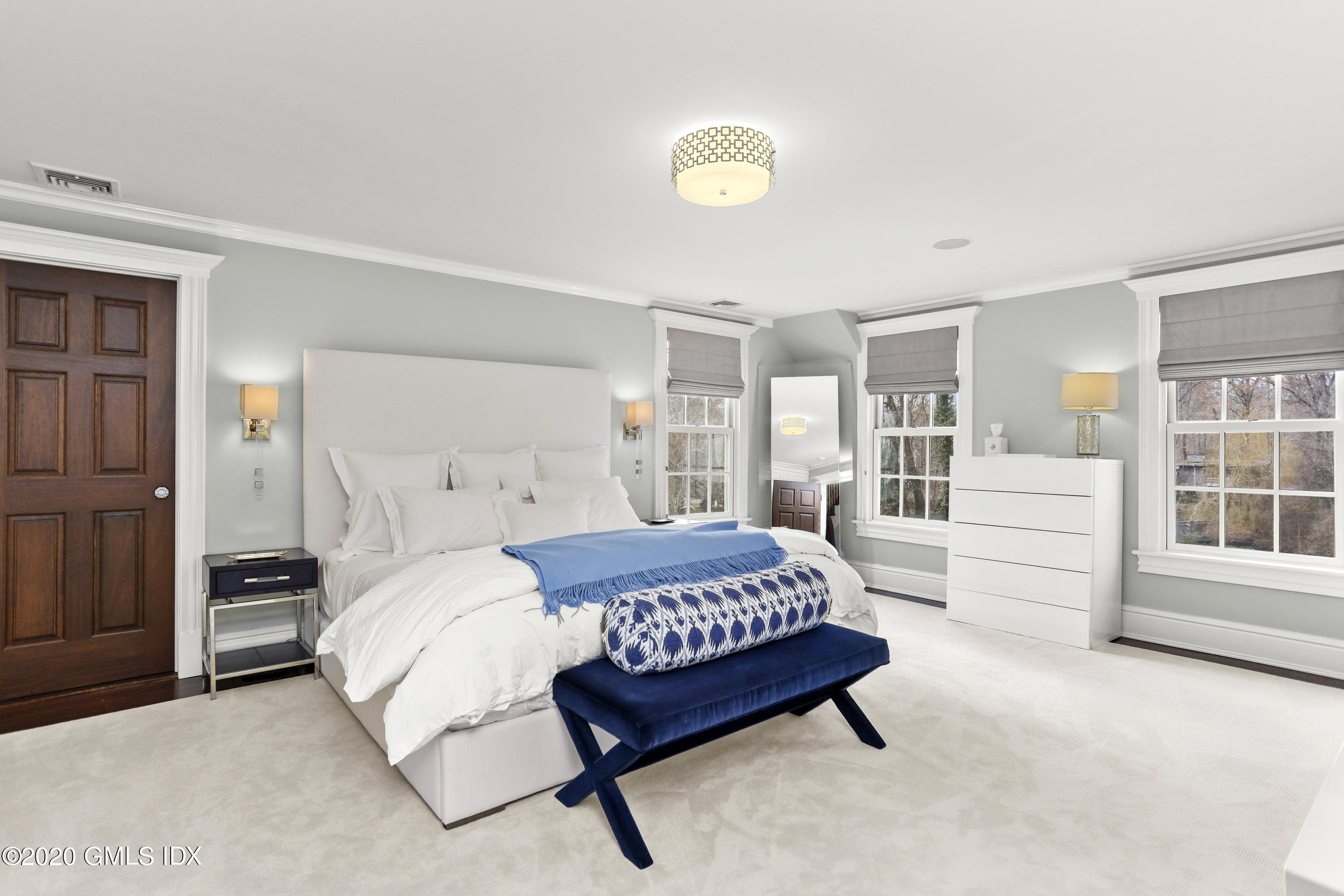 10 Brookridge Drive Greenwich, CT 06830 - Photo 12 of 36 a bedroom with a bed lamp and closet