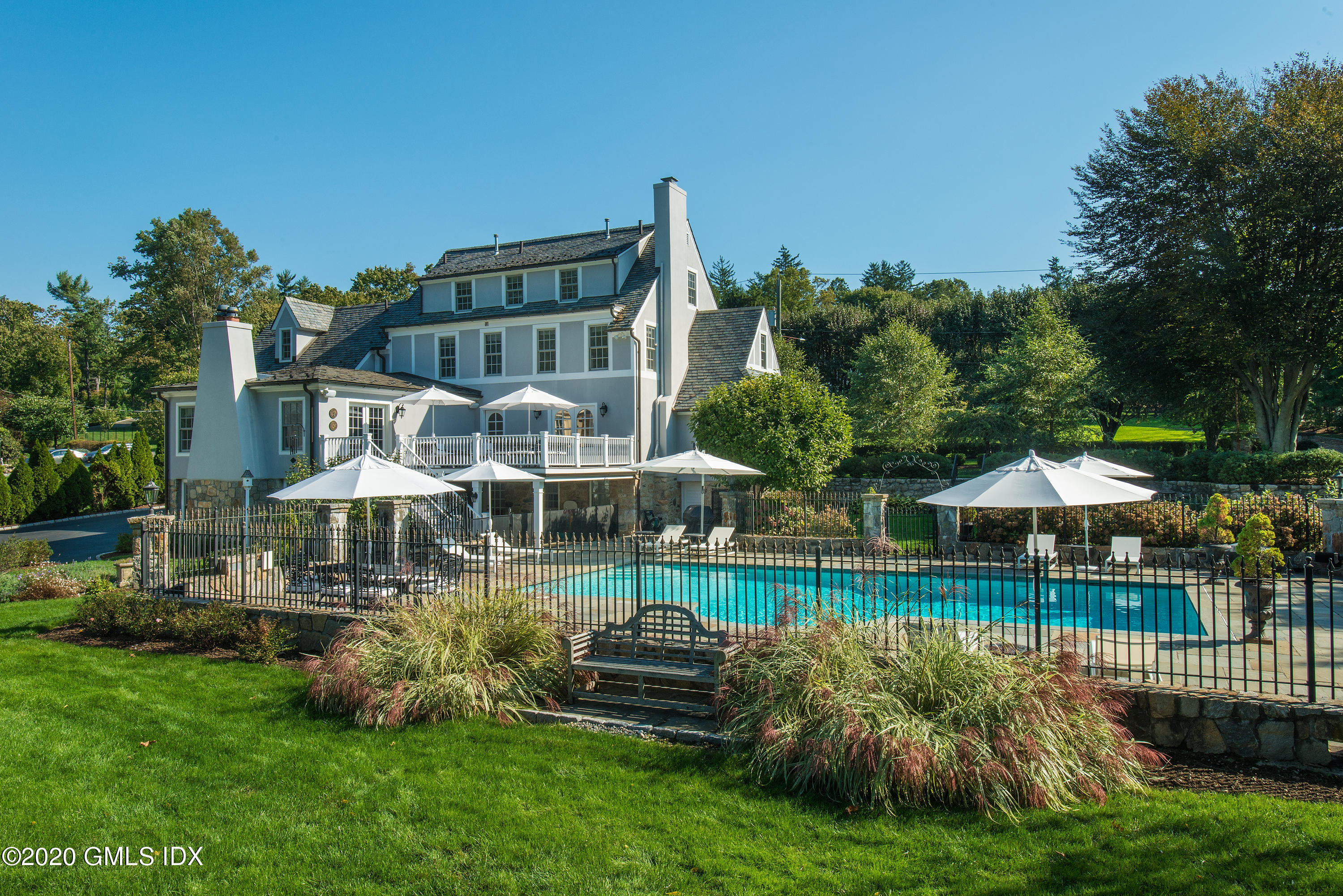 10 Brookridge Drive Greenwich, CT 06830 - Photo 29 of 36 a front view of a house with garden and a patio