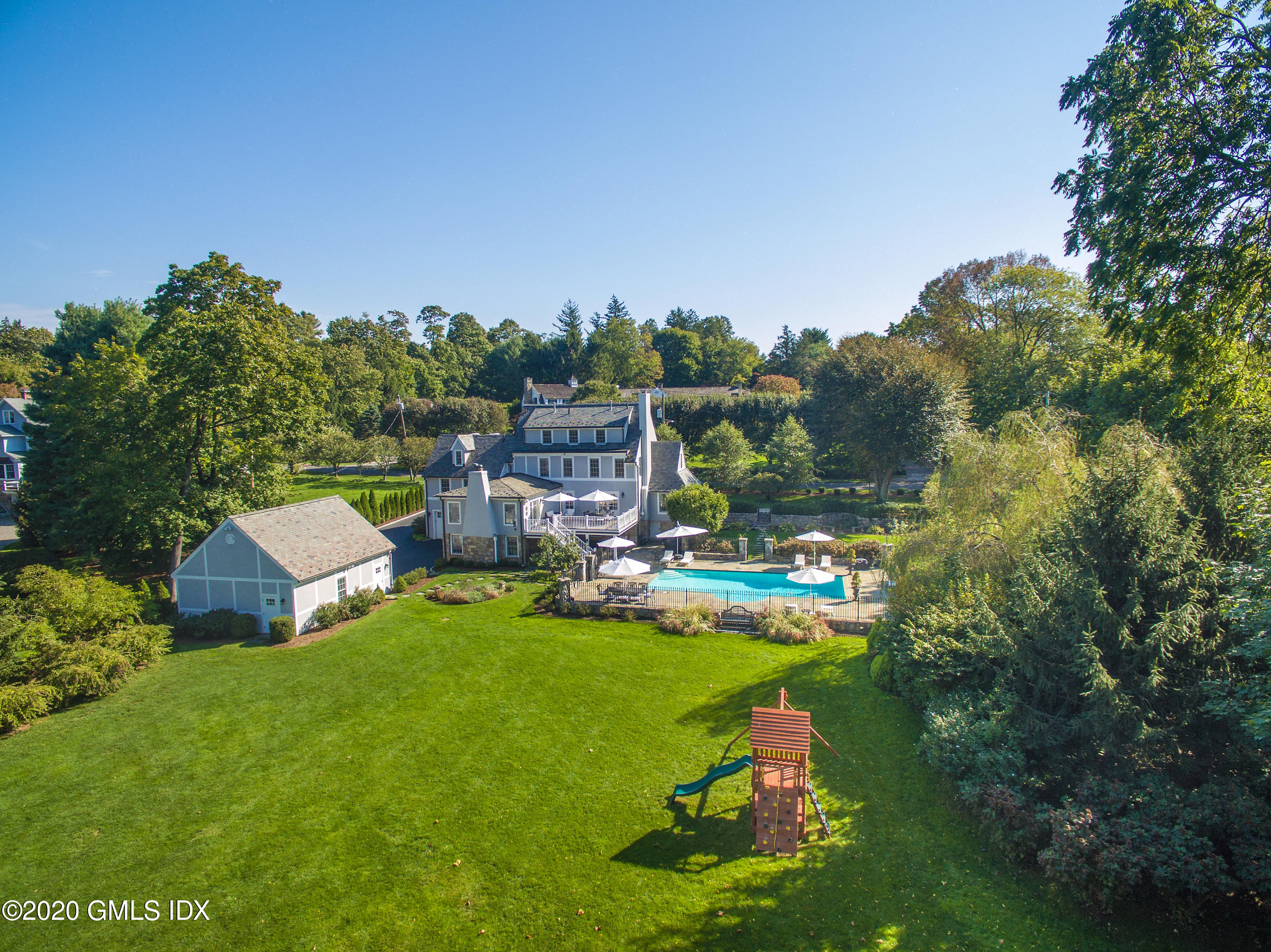 10 Brookridge Drive Greenwich, CT 06830 - Photo 30 of 36 a view of a garden with swimming pool and sitting area