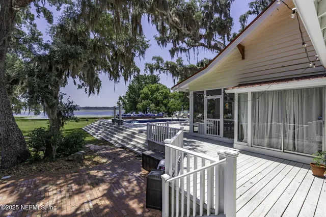 a living room with furniture a fireplace and a large mirror