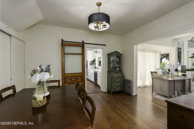 an aerial view of a house with a garden and lake view