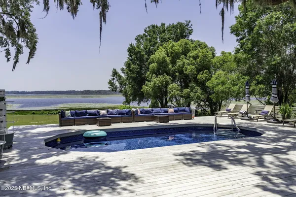 a view of a swimming pool with sitting area