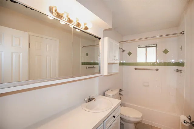 an empty room with a window and a chandelier fan