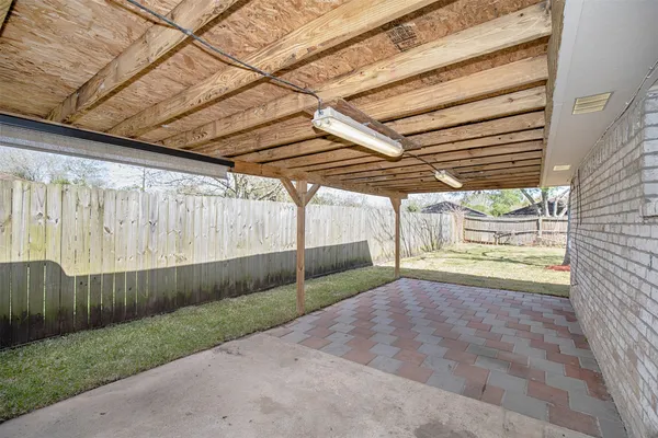 an empty room with a window and a ceiling fan