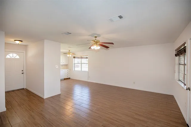 a view of a room with wooden floor
