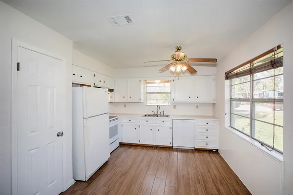 a view of a kitchen with wooden floor and a kitchen