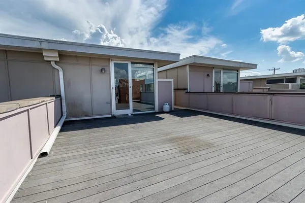 a view of a house with a wooden deck