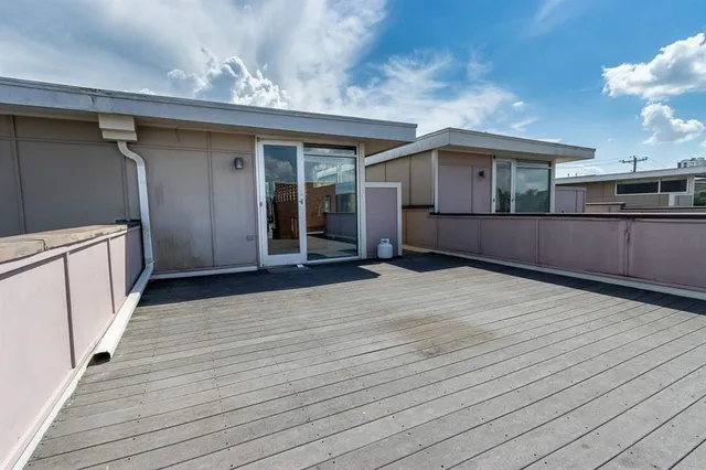 a view of a house with a wooden deck
