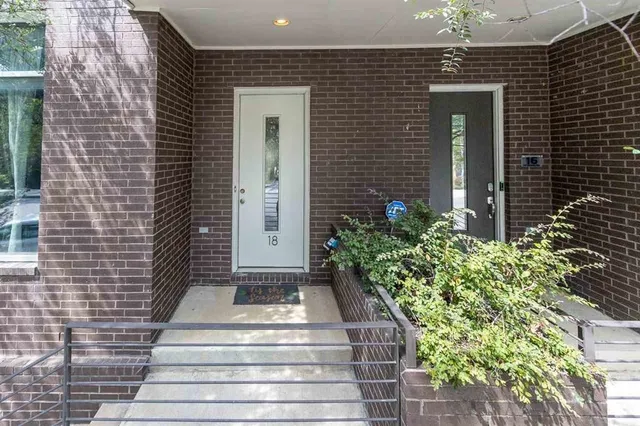 a front view of a house with plants