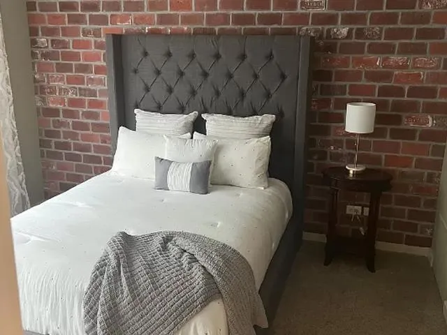 a bedroom with a bed and a mirror