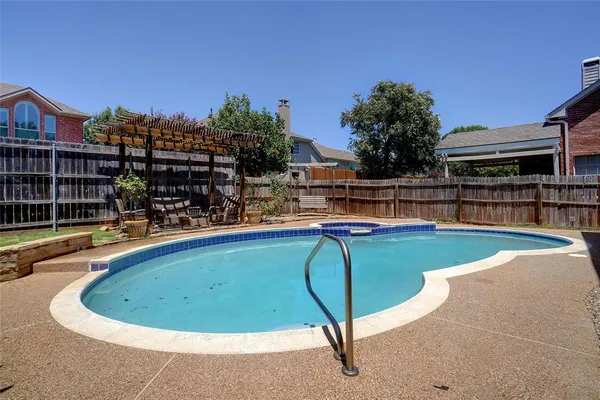 a view of a swimming pool with a lounge chairs