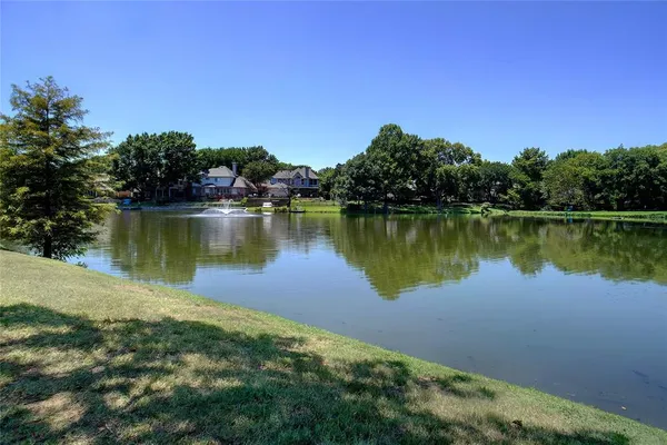 a view of a lake with a yard and mountain view