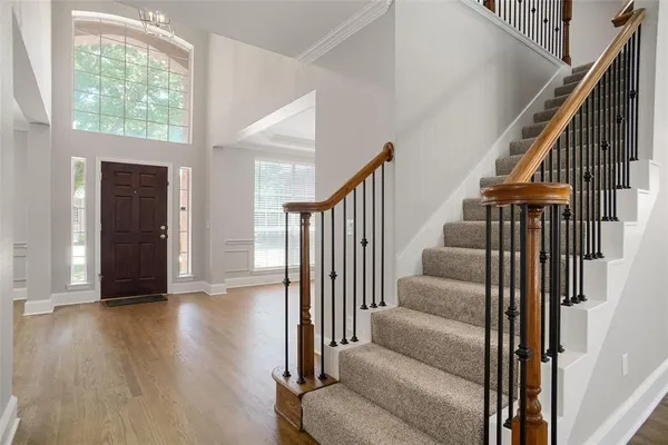 a view of entryway and hall with wooden floor
