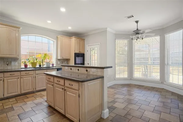 a kitchen with stainless steel appliances granite countertop a sink and a stove