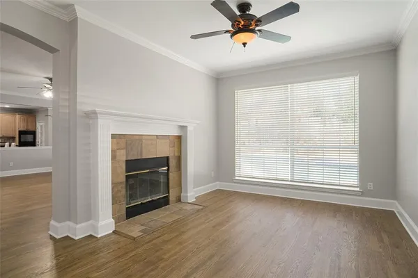 a view of an empty room with a fireplace and a window