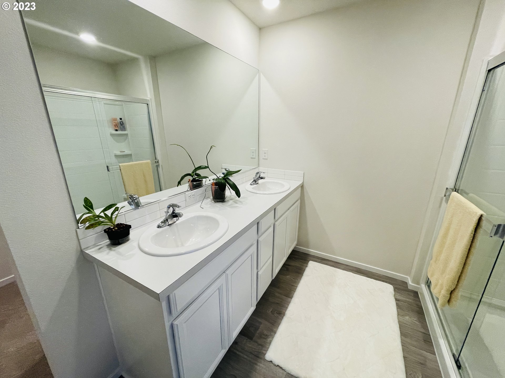 2927 W Street Springfield, OR 97477 - Photo 22 of 38 a bathroom with a sink and mirror with window