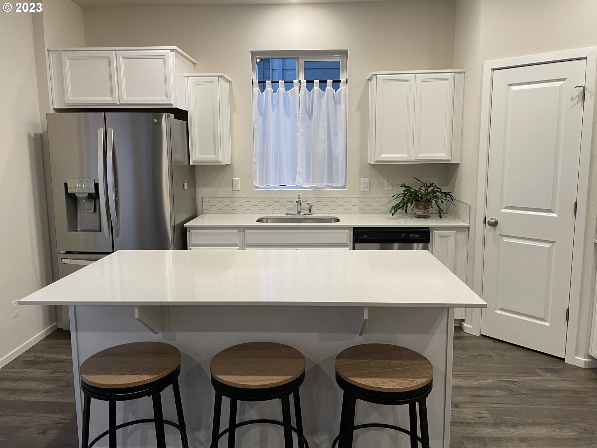 2927 W Street Springfield, OR 97477 - Photo 7 of 38 a kitchen with stainless steel appliances a table chairs and refrigerator