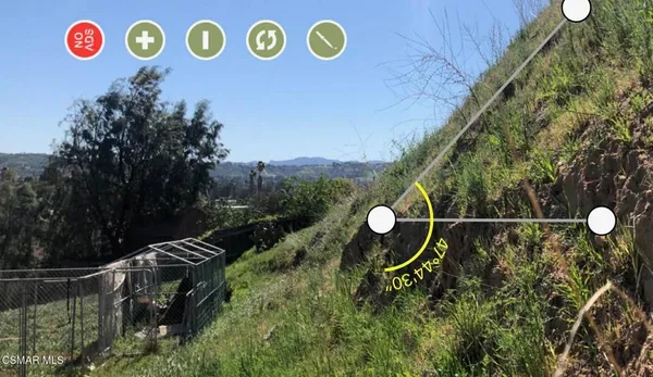 a backyard of a house with a table and chairs