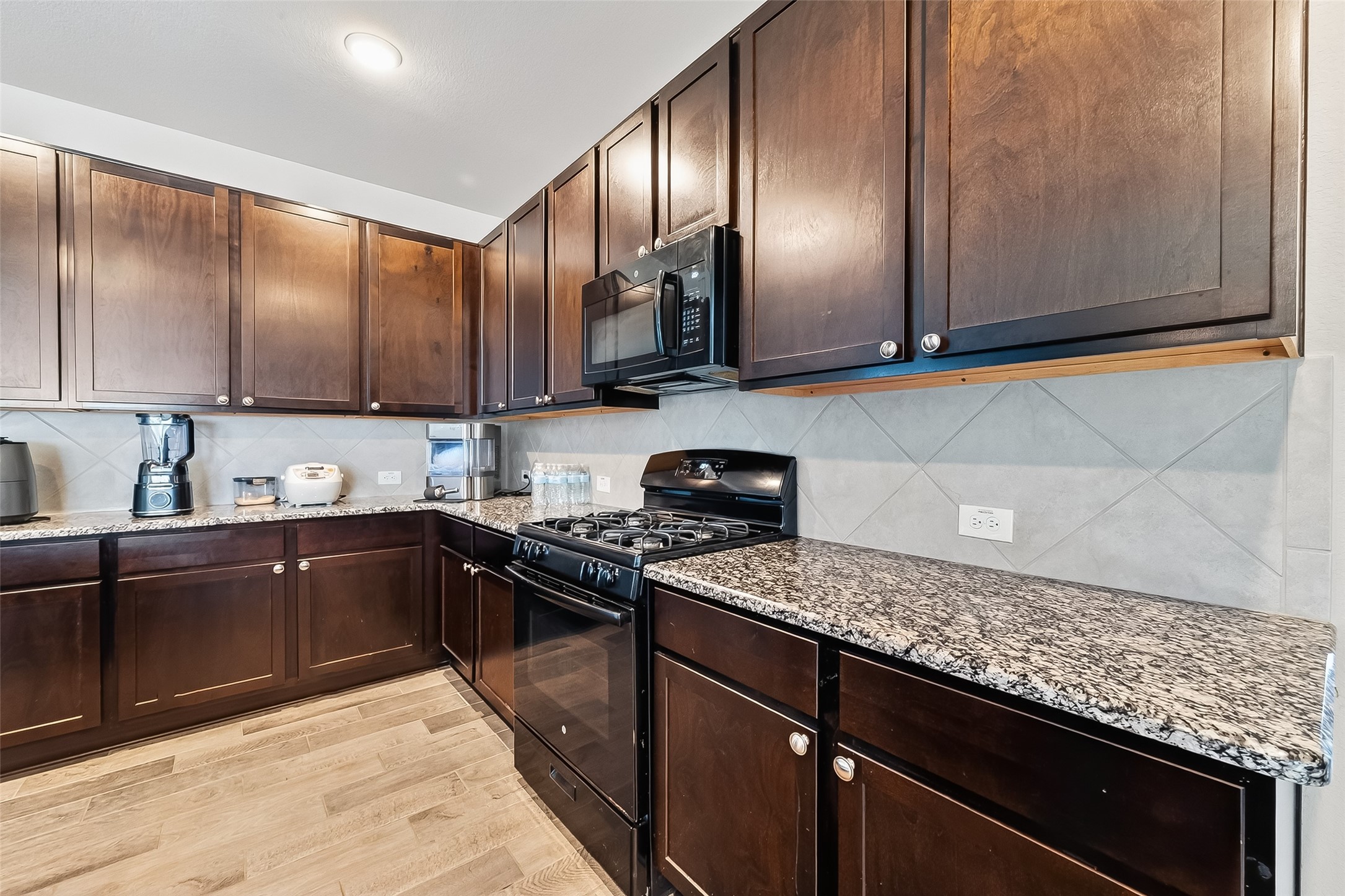 2422 Agassiz Drive Rosharon, TX 77583 - Photo 20 of 41 a kitchen with granite countertop stainless steel appliances and wooden cabinets