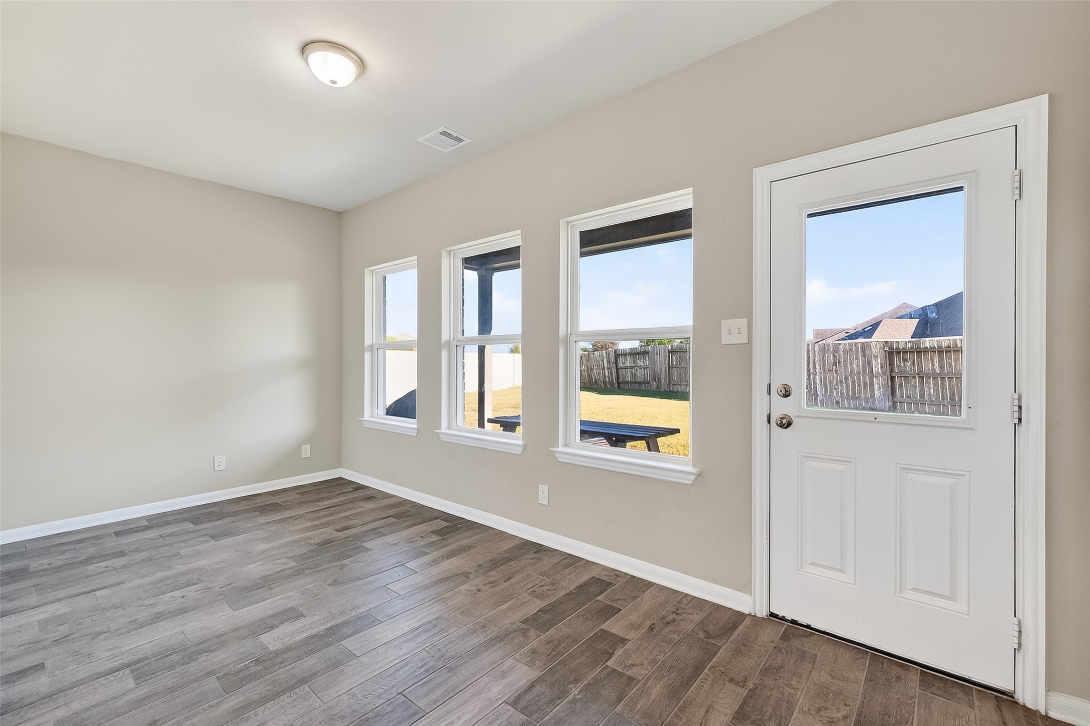 2422 Agassiz Drive Rosharon, TX 77583 - Photo 23 of 41 an empty room with wooden floor and windows