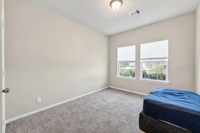 a room with a bed and a cabinet