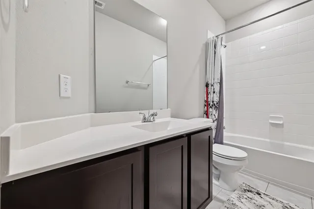 a bedroom with a bed and a tv